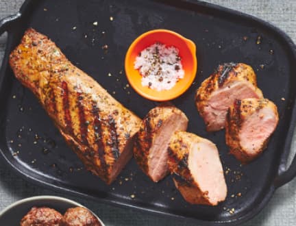 A picture of grilled meat served on a black plate