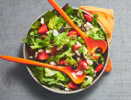 A picture of salad served on a grey plate
